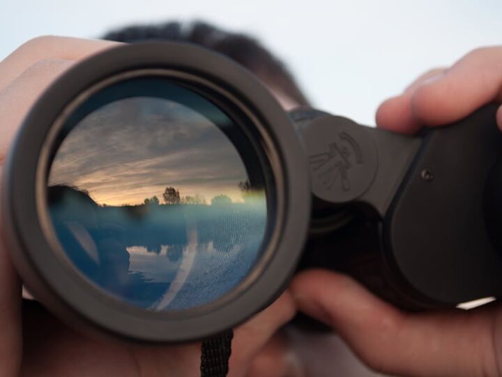 man looking through binoculars